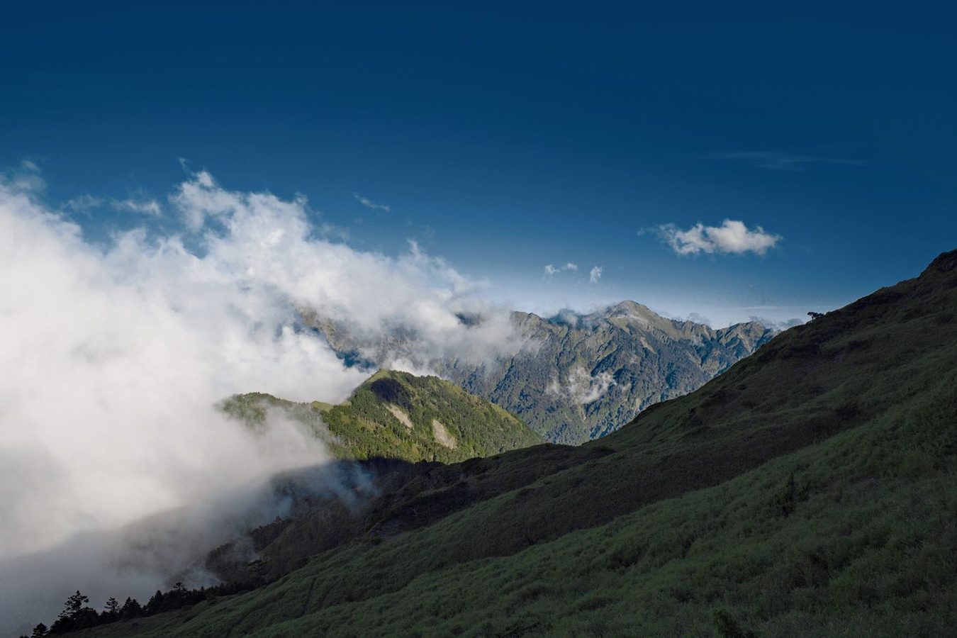Hehuanshan alpine meadow with rolling green peaks and clouds, Nantou