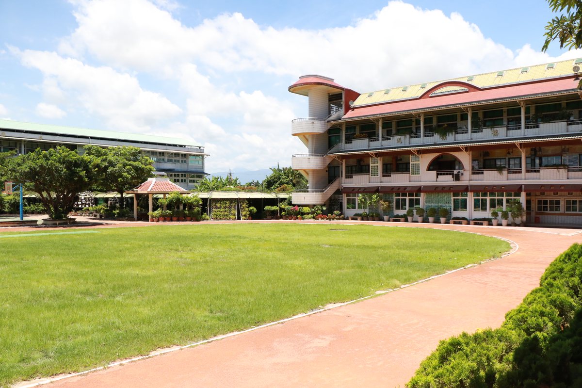 The curved main building and running track