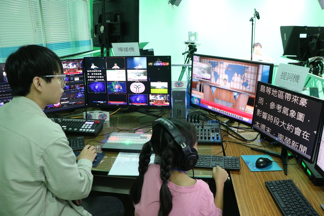 Students operating the vision mixer and teleprompter