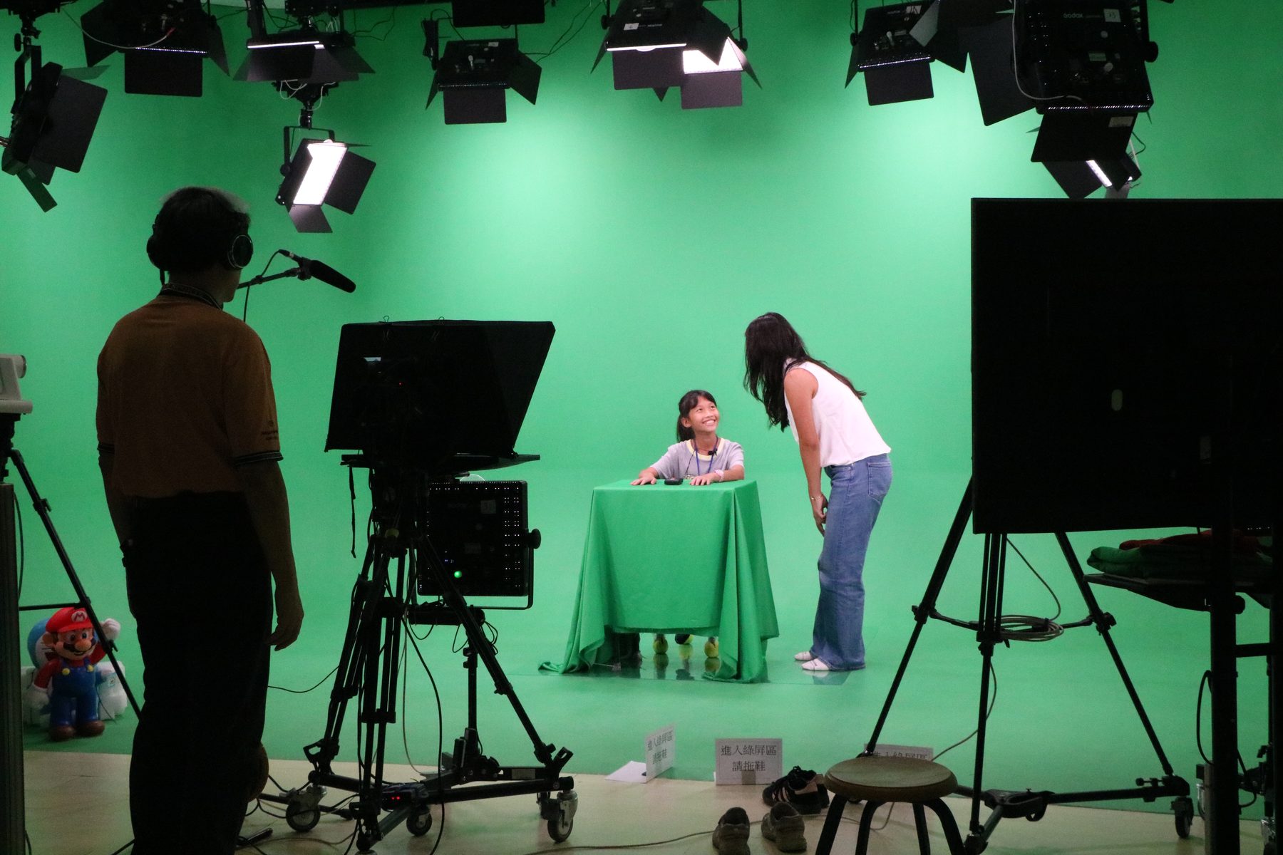 The green-screen broadcast studio with professional lighting