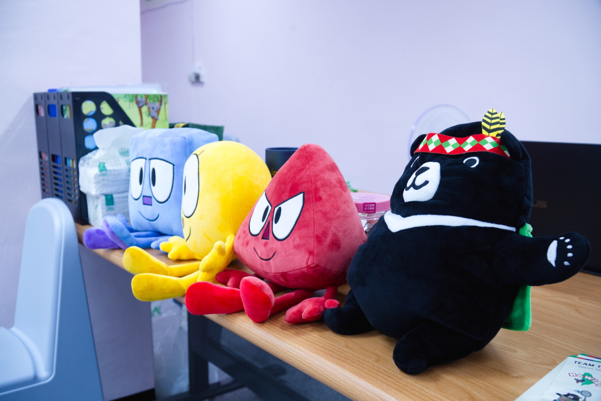Plush mascots representing the UN Sustainable Development Goals beside Taiwan's black bear mascot
