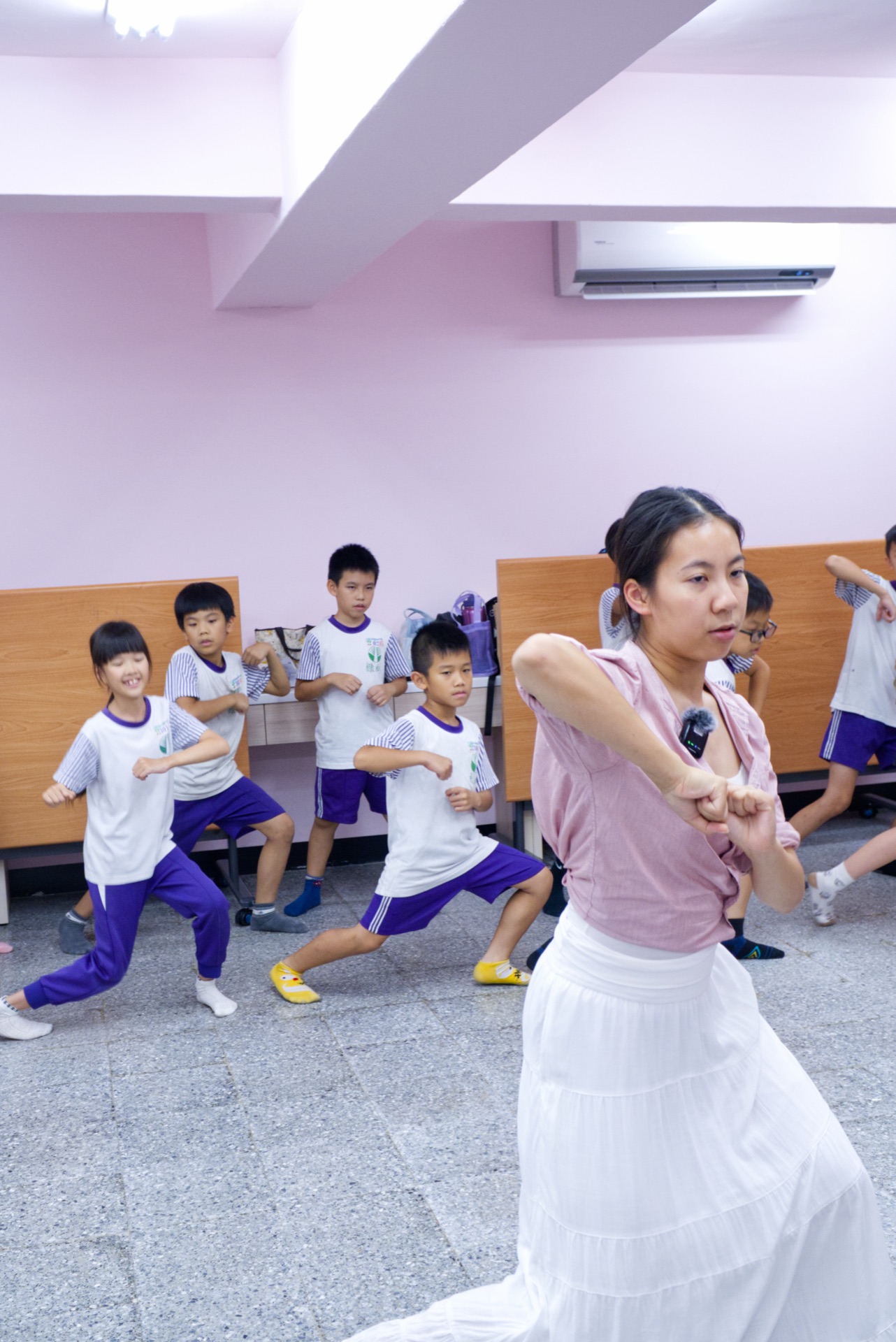 Teacher Kylie leads campers through choreography for the closing ceremony performance
