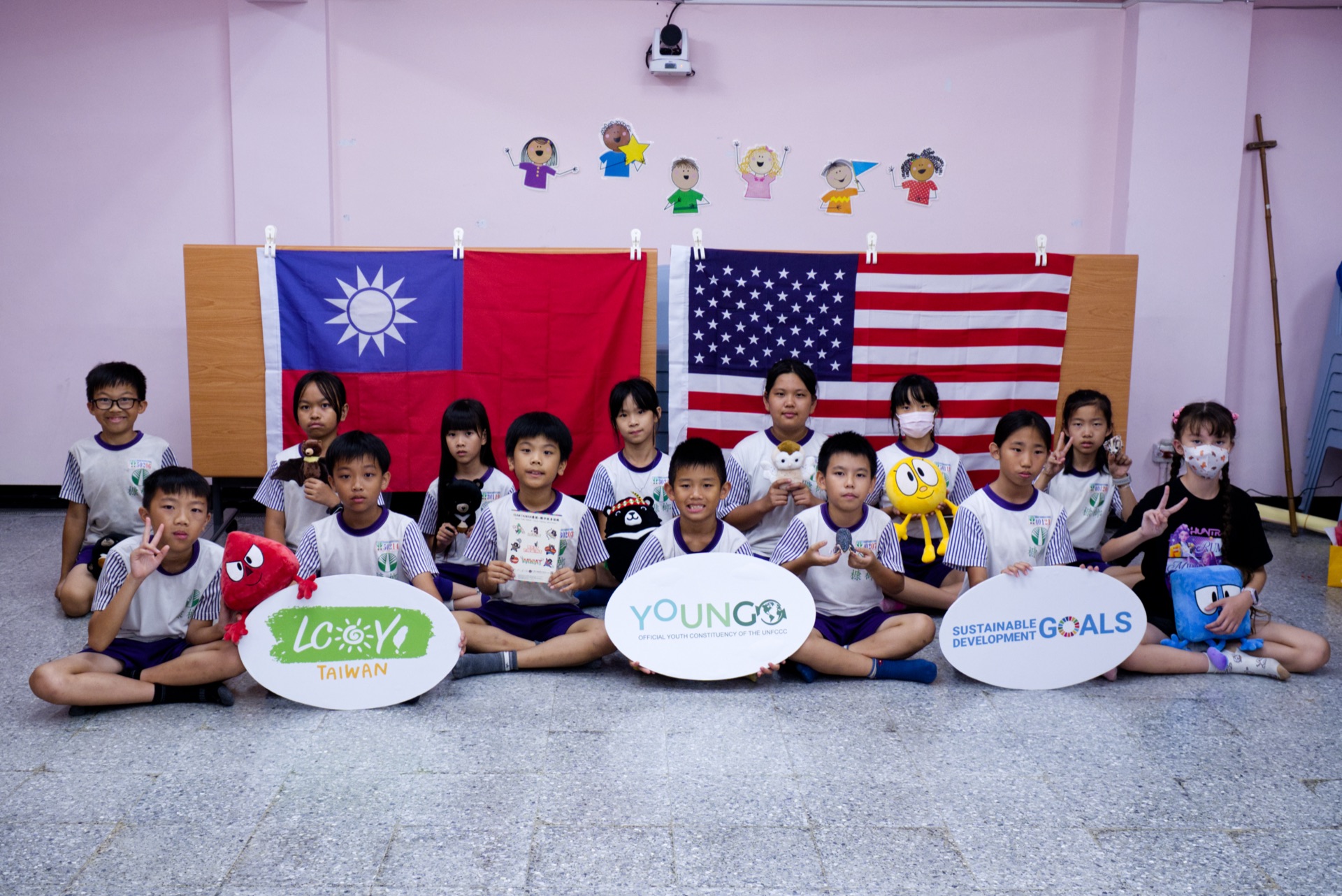 KangLang campers pose with the ROC and USA flags after their mock youth climate conference at the 2026 Immersive English Summer Camp